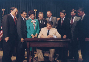 President Ronald Reagan signs the Civil Liberties Act of 1988 ...
