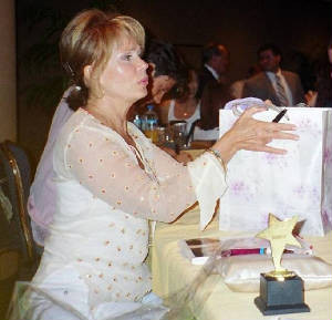 Julia receives a gift bag from the members of the Barr Association