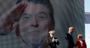 Nancy Reagan stands in front of a Ronald Reagan photo backdrop. | AP ...