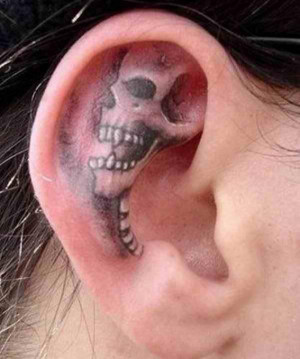 skull tattoo embossed on the ear.