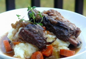 Beef Short Ribs baked in a Dutch oven with a bottle of red wine, herbs ...