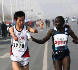 slows down to offer her water to a disabled runner. She got 2nd place ...