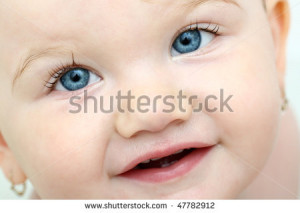 Baby Girl Looking Straight Into Camera With Her Blue Eyes While Taking