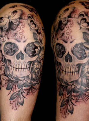 Tattoo skull is decorated with flowers tattoo