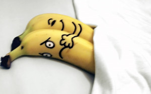 Funny banana romantic couple in bed