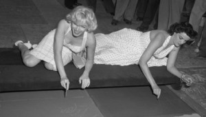 Actresses Marilyn Monroe and Jane Russell putting signatures, hand and ...
