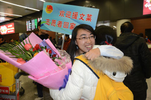 volunteers are greeted at shenyang airport in liaoning province on