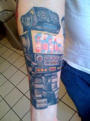 tattoo of a piston robot.