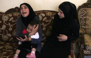 The wife of Ali al-Sayyed held her daughter and mourned the death of ...