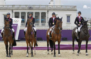 Britain's equestrian team jumping members sit on their horses with ...