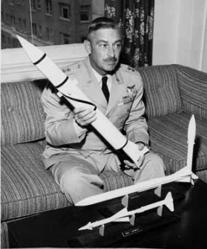 General John B. Medaris holding a model of the Redstone rocket at a ...