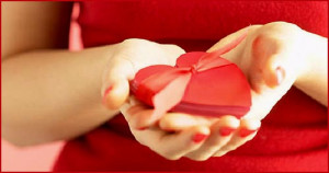 ... hearts photo: Picture of woman holding a red heart in both her hands