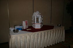 wishing well on the gift table of a wedding reception.