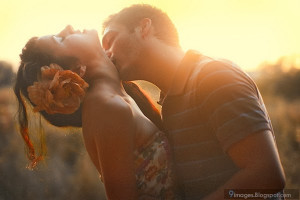 Romantic couple dreamy sunset kiss on girl neck