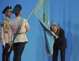 Kazakh President Nursultan Nazarbayev kissing the national flag during ...
