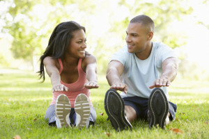 Couple Exercising In Park