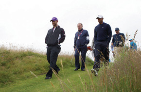 Tiger Woods of the United States, third left, walks down a fairway ...