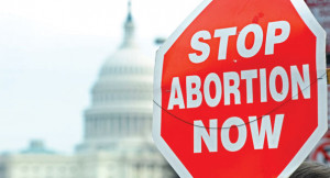 sign reading 'Stop abortion now' is pictured in front of the Capitol ...