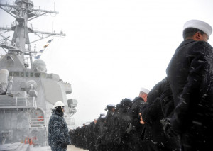 Sailors aboard the USS Lassen (DDG-82) man the rails during a sea and ...