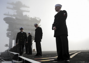Sailors aboard the aircraft carrier USS Nimitz (CVN 68) prepare to man ...