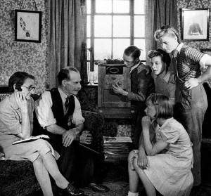 Mr. and Mrs. Cooper and family tuning their wireless to listen to a ...