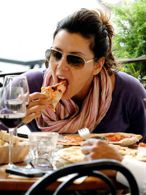 Eva Longoria eating pizza on her cheat day.