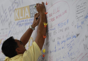 man writes a message for the passengers of the missing Malaysian ...
