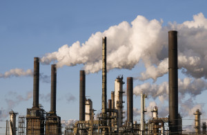 Oil refinery with smoke stacks against a blue sky ©iStockphoto.com ...