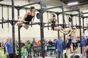 Erin Taylor, left, Jess Core's partner, competes in Bar Muscle Ups ...