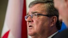 Finance Minister Jim Flaherty speaks at a press conference for the ...
