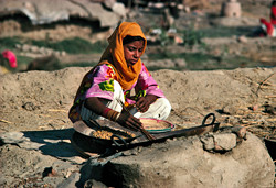 young girl cooking a meal in Lahore, Pakistan.