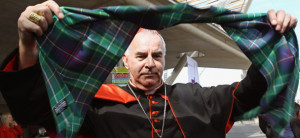 Cardinal Keith O'Brien holds aloft a special tartan commissioned to ...