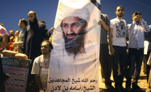 Demonstrators carry a poster of Osama bin Laden during a protest ...