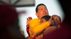 Venezuela's President Hugo Chavez embraces a boy during a campaign ...