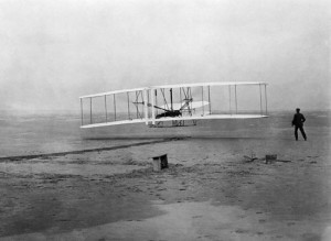 The Wright Flyer becomes airborne under the control of Orville Wright