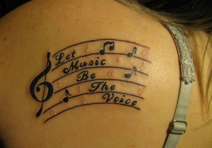 quotes-and-music-symbol-tattoo-design-for-girl-on-shoulder