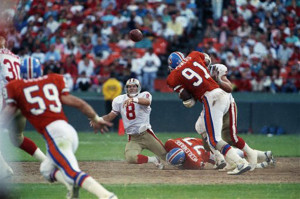 Karl Mecklenburg (77) making a shoe-string tackle on the 49ers ...