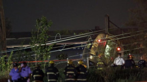 Emergency personnel work the scene of a deadly train wreck, Tuesday ...