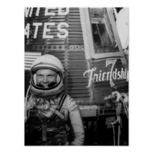 Astronaut John Glenn poses beside Friendship 7 Posters