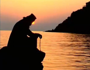 monk praying sunset