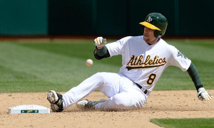 Oakland Athletics shortstop Jed Lowrie slides into second base after ...