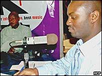 Andrew Mwenda r and President Yoweri Museveni l