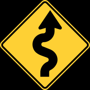 and Canada winding road ahead sign.