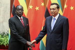 ... Li Keqiang shake hands during their meeting at the Great Hall of the