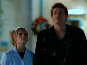 Angel and Buffy walk while it snows.
