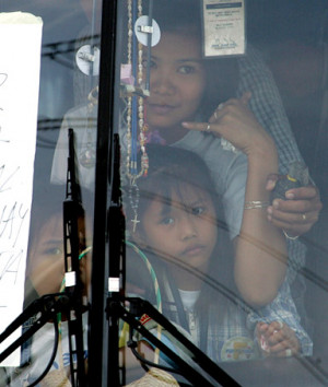 hostage gestures for a cellphone as a grenade is held close to her ...