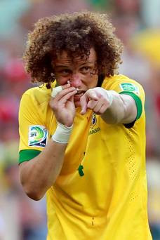 FORTALEZA, BRAZIL - JUNE 19: David Luiz of Brazil tends to his injured ...