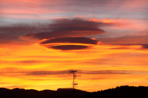 lenticular cloud formation (also known as a UFO cloud) is seen ...