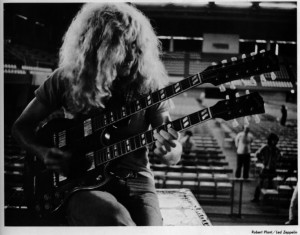 Robert Plant plays a double neck guitar Image