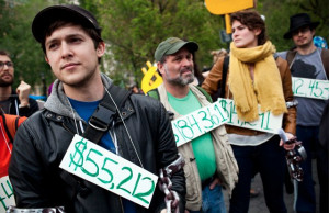 Occupy Wall Street demonstrators displaying their student loan debts ...